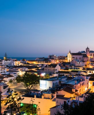 Albufeira, Portugal - April 16: Panoramic, night view of the Old Town of Albufeira City in Algarve, Portugal. Albufeira is a coastal city in the southern Algarve region of Portugal. It’s a former fishing village that has become a major holiday destination.