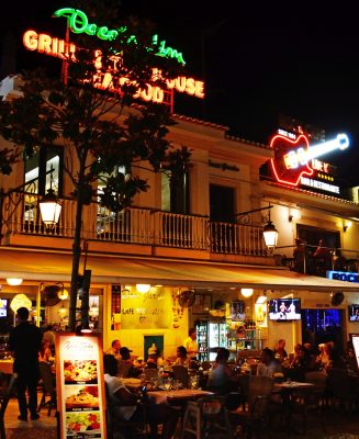 Tourists relaxing bars and restaurants in the Largo Duarte Pachero Square in the old town at night, Albufeira, Portugal, Europe.